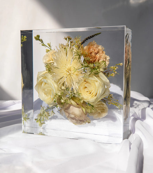 Front view of an 8x8 resin block featuring preserved wedding flowers as a keepsake.