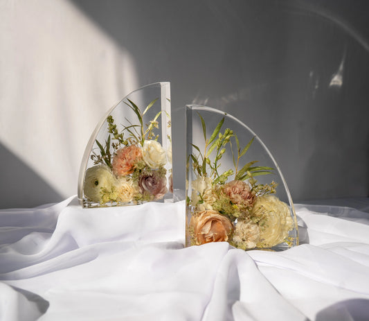 Matching set of resin bookends with preserved wedding flowers arranged in clear epoxy.
