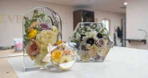 Large arch and hexagon resin keepsakes with preserved wedding flowers displayed in the Everlasting Bloom Co. studio