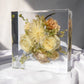 Front view of an 8x8 resin block featuring preserved wedding flowers as a keepsake.