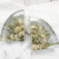 Set of clear resin bookends featuring preserved neutral and green-toned wedding flowers with textured greenery, arranged in a modern curved design — handcrafted floral preservation by Everlasting Bloom Co.