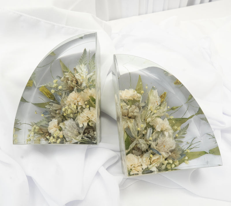 Set of clear resin bookends featuring preserved neutral and green-toned wedding flowers with textured greenery, arranged in a modern curved design — handcrafted floral preservation by Everlasting Bloom Co.