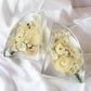 Set of clear resin bookends featuring preserved white and cream wedding flowers arranged in a modern curved design — handcrafted floral preservation by Everlasting Bloom Co.