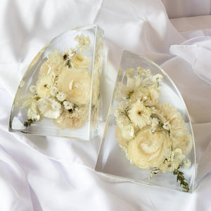 Set of clear resin bookends featuring preserved white and cream wedding flowers arranged in a modern curved design — handcrafted floral preservation by Everlasting Bloom Co.