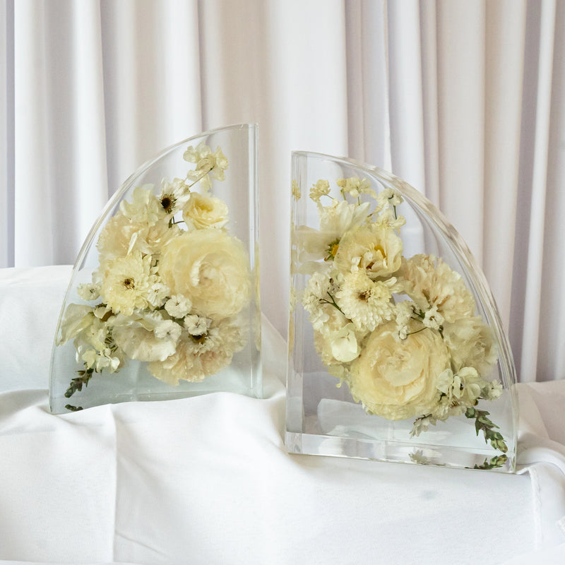 Handmade resin bookends showcasing preserved cream and white wedding blooms in a contemporary curved shape — floral keepsake by Everlasting Bloom Co.