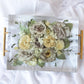 Rectangular resin tray with preserved yellow and neutral wedding flowers, paired with gold handles and styled on soft white fabric — floral preservation by Everlasting Bloom Co.