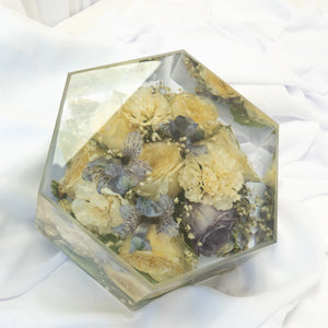 Hexagon-shaped resin block featuring preserved yellow roses, cream florals, and soft blue blooms arranged in a clear, handcrafted display — wedding flower preservation by Everlasting Bloom Co.