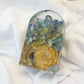 Small arch-shaped resin block featuring preserved yellow roses and blue hydrangeas, arranged in a clear handcrafted display — wedding flower preservation by Everlasting Bloom Co.