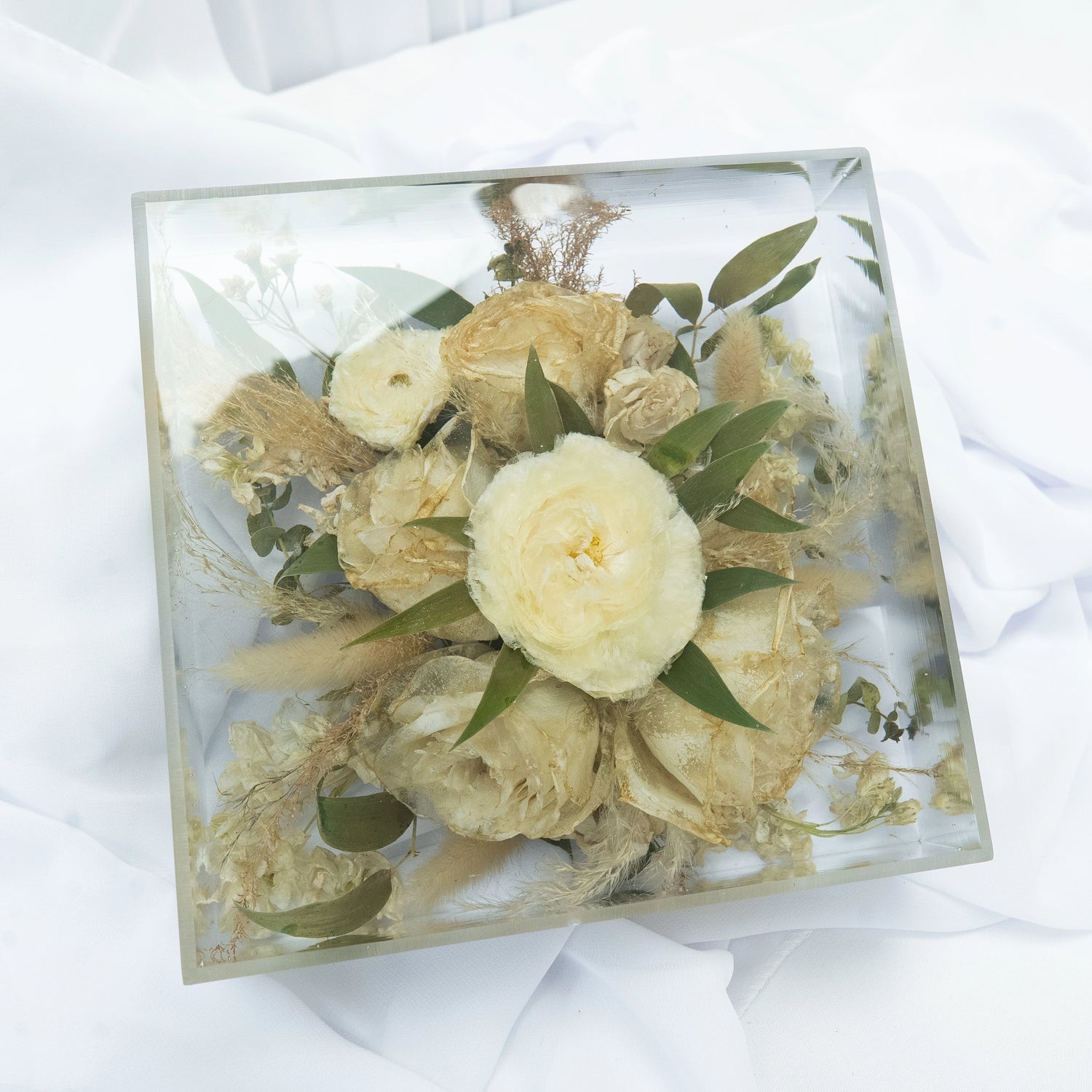 Square resin floral block featuring preserved cream and white wedding flowers with natural greenery, arranged in a clear, modern display — handcrafted flower preservation by Everlasting Bloom Co.