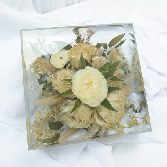 Square resin floral block featuring preserved cream and white wedding flowers with natural greenery, arranged in a clear, modern display — handcrafted flower preservation by Everlasting Bloom Co.