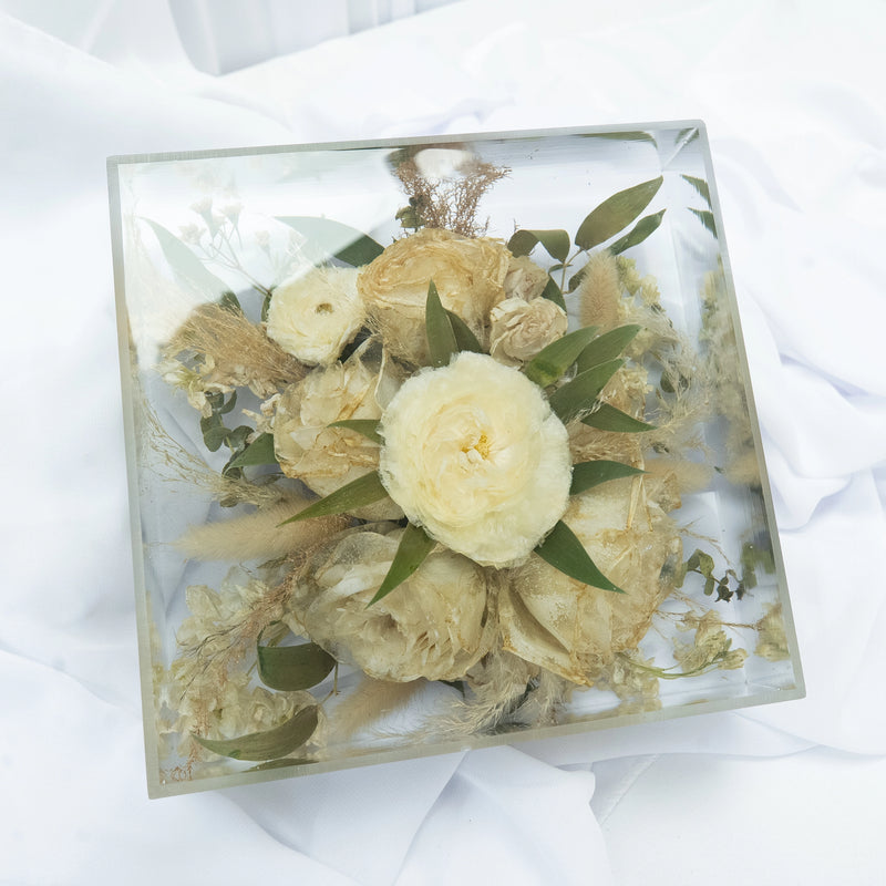 Square resin floral block featuring preserved cream and white wedding flowers with natural greenery, arranged in a clear, modern display — handcrafted flower preservation by Everlasting Bloom Co.