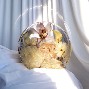Standing circle resin keepsake featuring preserved cream and blush flowers with orchids and peonies, capturing wedding blooms in a modern half-sphere design.