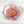 Scalloped-edge coaster with a single dusty pink garden rose from a wedding bouquet