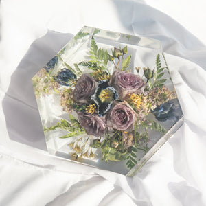 Hexagonal resin keepsake with preserved lavender roses, navy anemone, green fern, and yellow yarrow from a wedding bouquet