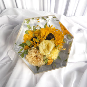 Hexagon resin flower preservation featuring vibrant sunflowers, yellow lisianthus, and ivory roses — custom bridal bouquet keepsake in clear epoxy