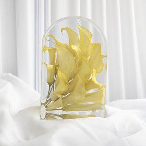 Large arch with a cascade of yellow calla lilies from a wedding bouquet