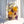Large clear resin arch keepsake with preserved yellow roses, purple roses, blush carnations, and baby's breath from a wedding bouquet.