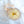 Round resin ornament with peach silk ribbon, preserved ivory peony from a wedding bouquet