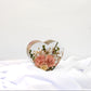 Custom floral keepsake in a heart resin mold, preserving petals from a special occasion bouquet.