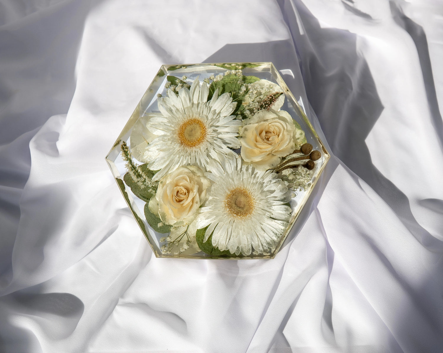 Top-down view of hexagon resin mold showcasing preserved wedding bouquet flowers.