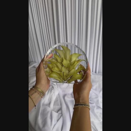 Short video of a small standing circle resin keepsake made from preserved wedding blooms.