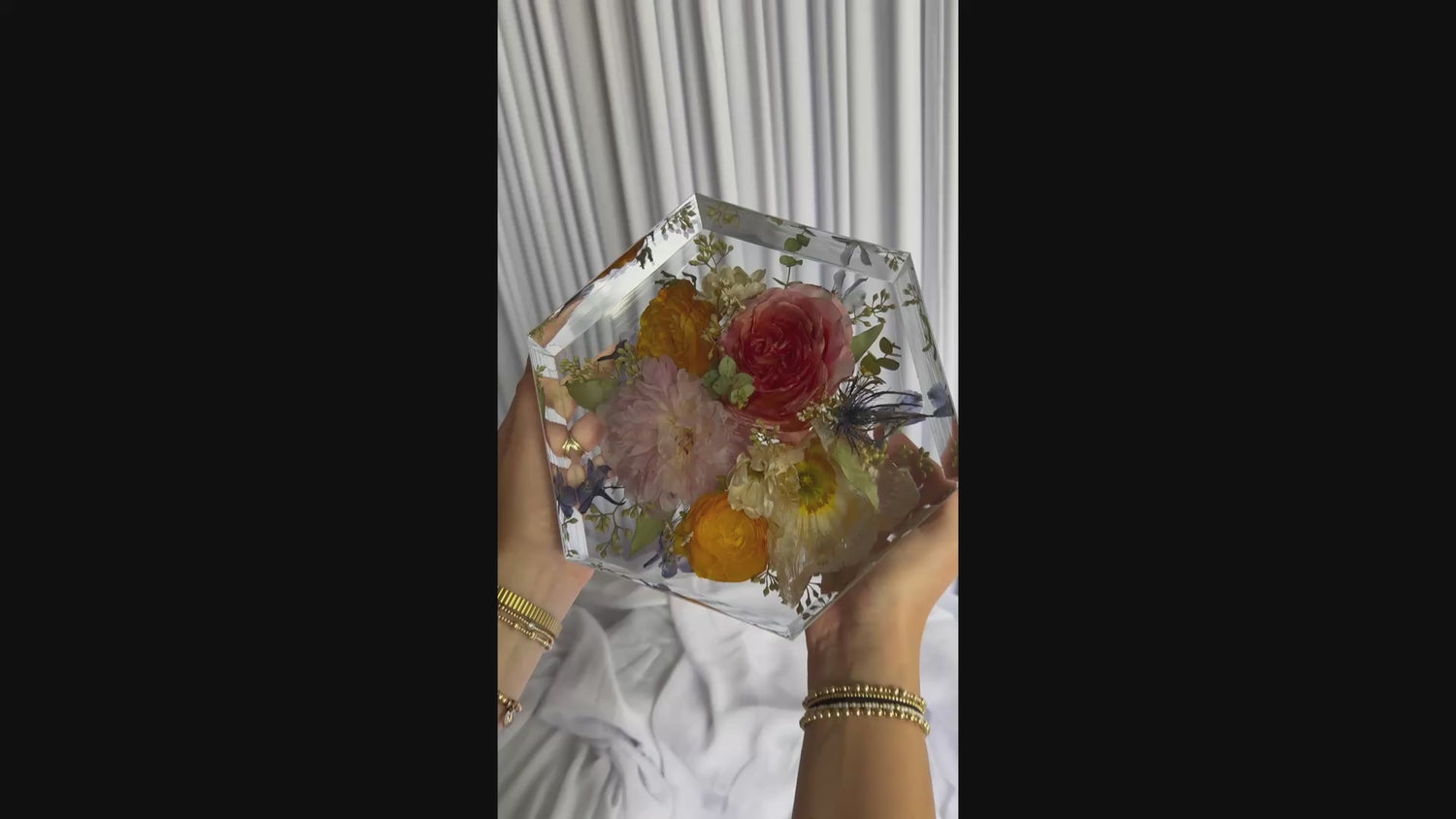8-second video showcasing a hexagon-shaped resin keepsake made from real wedding flowers.