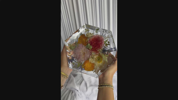8-second video showcasing a hexagon-shaped resin keepsake made from real wedding flowers.