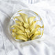 Resin standing circle keepsake featuring preserved yellow calla lilies, displayed on soft white fabric.
