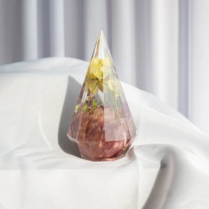 Faceted pyramid resin ring holder with preserved mauve rose and yellow florets from a wedding bouquet