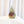 Faceted pyramid resin ring holder with preserved rust rose, green fern, and yellow baby's breath from a wedding bouquet