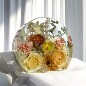 Standing circle resin flower preservation with preserved yellow roses, pink carnations, and mixed greenery displayed in clear epoxy — custom bridal bouquet keepsake