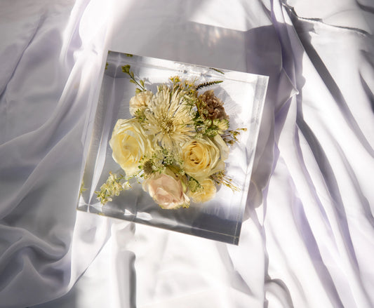 Top-down view of a square resin block showcasing vibrant preserved bouquet flowers.